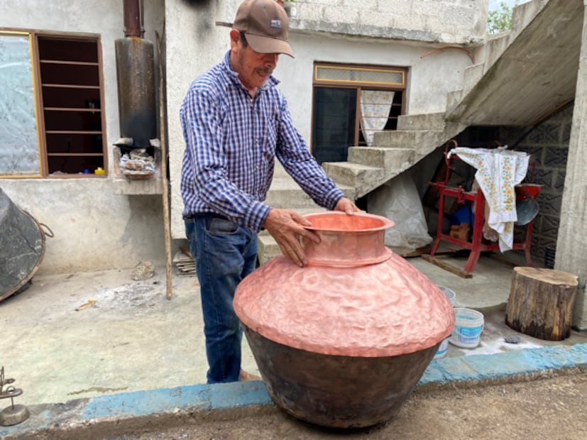 Luciano Guzmán Gutiérrez pone sus manos ya curtidas sobre el vientre redondo de un alambique recién creado. Dice que “cada uno tiene su propio carácter”, como si hablara de una persona. I Foto: Luis Soriano