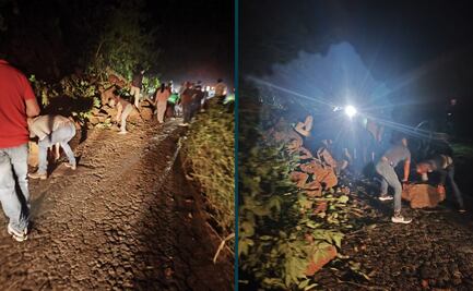 Pasajeros despejan derrumbe en la carretera Huejutla-Pachuca para continuar su viaje